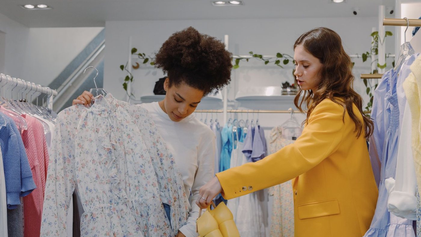 Two customers comparing items in a shop